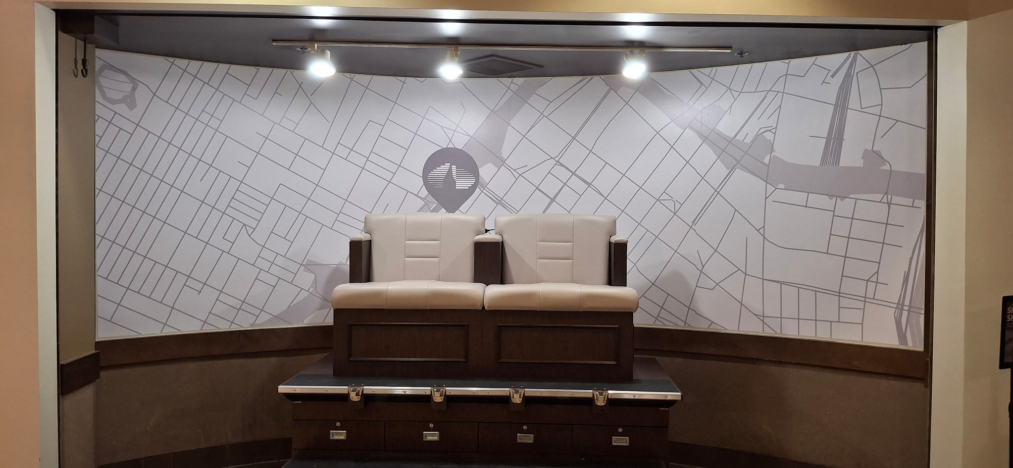 Large-format gray street-map wall wrap spanning a recessed seating area